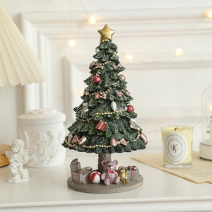 Miniature green resin Christmas tree with gold star, red ornaments and pink bear base