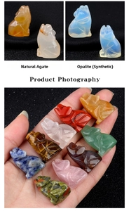 Hand holding various mini hand-carved natural gemstone wolf statues for scale