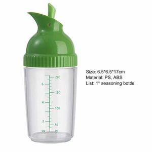 Detail view of transparent seasoning bottle with 200ml scale markings and green lid