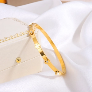 Detailed close-up of golden clover petals with sparkling diamonds on silk background