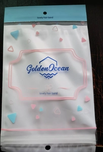 Detail of translucent plastic hair band packaging with blue seal and colorful patterns