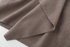 Detailed close-up showing the premium texture and weave of the brown knit fabric