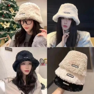 Detail of plush bear ear bucket hat in white, beige and black faux fur texture
