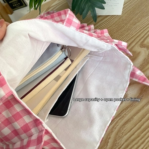 Internal view of plaid tote bag showing large capacity, open inner pocket and thick lining