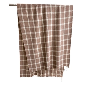 Classic brown and white plaid cashmere-like scarf with soft fringe on a clean background