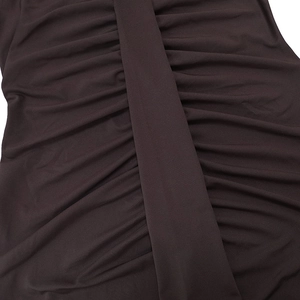 Macro shot of the deep brown ruched fabric texture and pleated design on this dress