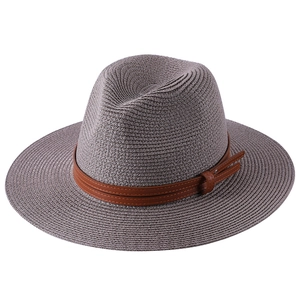 Foldable taupe straw Panama hat for women with brown faux leather band on white background