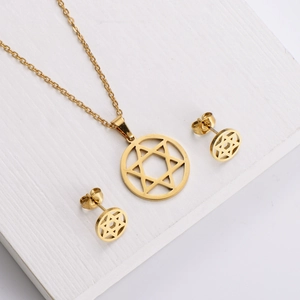 Close-up of gold stainless steel jewelry set with hexagram pendants and studs