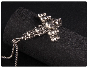 Macro view of silver skull cross pendant with intricate gothic punk metal textures