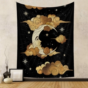 Detail of a celestial black wall tapestry featuring a golden moon and sun in a cozy room