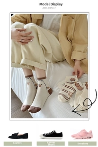 Detailed view of beige cotton socks with brown trim and cute capybara patterns