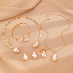 Golden baroque pearl jewelry set with necklace bracelet and earrings on silk