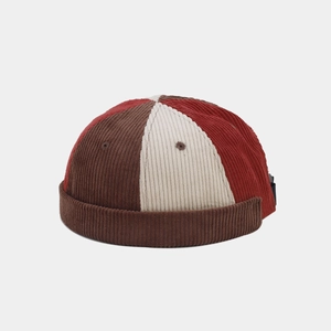 Detail view of the multi-color patchwork corduroy docker cap with adjustable side strap