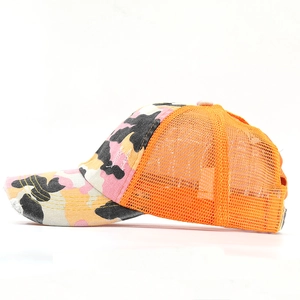 Detail view of the camouflage baseball cap showing orange mesh and cotton fabric textures