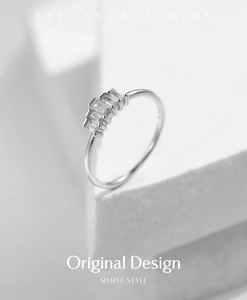 Artistic macro shot of S925 sterling silver crown ring with five rectangular diamonds