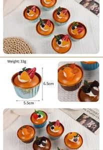Macro detail of PU foam cupcake model with strawberry and orange slices decor