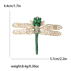 Detail view of alloy dragonfly brooch with green enamel and white rhinestones decoration