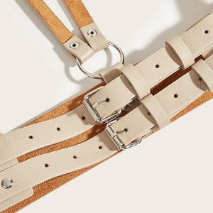 Close-up of beige punk style double buckle waist belt with silver metal ring and soft lining