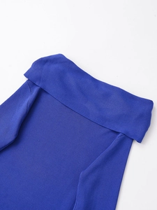 Close-up of royal blue knitted top featuring vertical rib texture and off-shoulder neckline