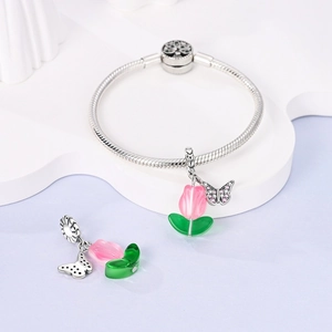 Detailed shot of silver snake chain bracelet with pink tulip and purple zircon charms