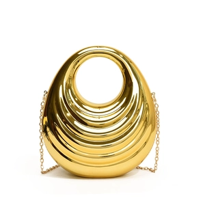 Golden acrylic hard shell evening bag with unique circular hollow design and chain strap