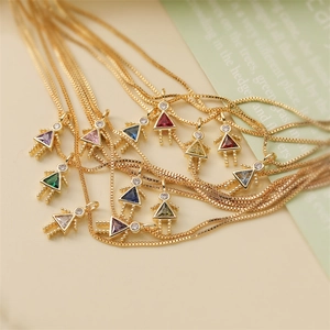 Macro shot of assorted gold box chain necklaces with colorful birthstone girl pendants
