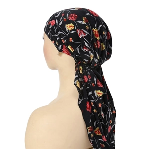 Detail of floral printed headscarf with long tails on black fabric for women