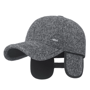 Winter men's herringbone grey wool cap with warm earflaps and metal China badge