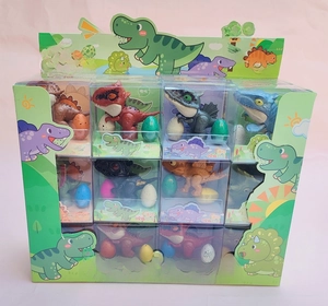 Bulk display of 24 mini dinosaur finger toys with matching eggs in a green retail box