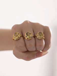 Detail of three-piece celestial gold rings with evil eye and star zircon inlays