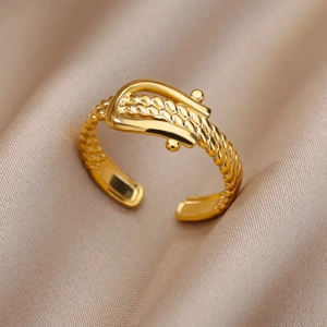 Close-up of 18k gold plated stainless steel ring with woven buckle design on silk