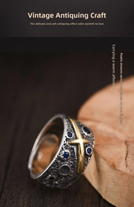Macro detail of retro meteorite texture ring with golden cross and blue sapphires