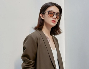 Fashionable amber round frame sunglasses with light orange lenses on a professional model