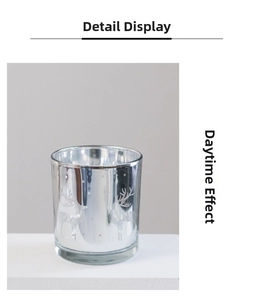 Detail of silver mercury glass candle holder with reindeer pattern in daytime light