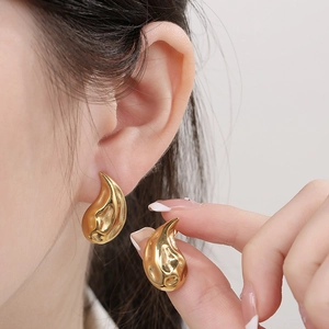 Macro shot of 18K gold plated stainless steel teardrop earrings with a hammered texture