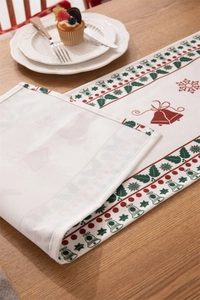 Detail of Christmas table runner with bells print showing hemmed edges on wooden table