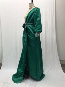 Close-up of emerald satin evening gown featuring silver sequin sleeve embroidery details