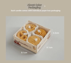 Primer plano de cuatro velas aromáticas en forma de galleta en caja de regalo con osito