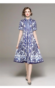Detailed view of short-sleeve floral dress with waist belt and elegant bow neckline
