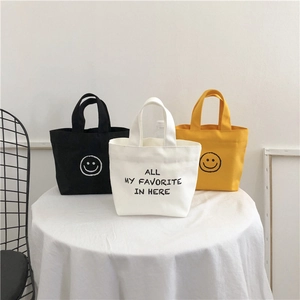 Mini canvas tote bags with smile print in black, yellow and white for women