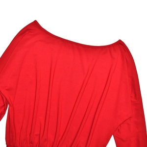 Detail view of red long sleeve top showing soft draped fabric and elegant round neckline