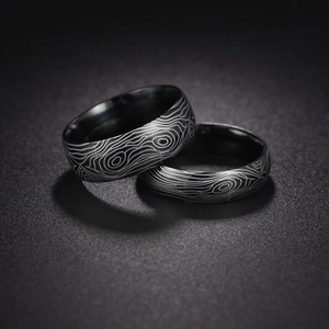 Macro detail of Damascus pattern titanium steel rings with polished inner surface