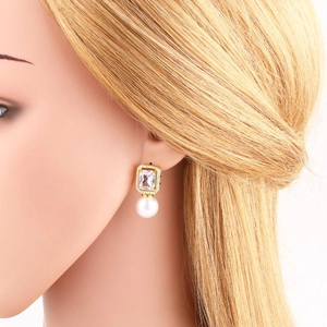 Elegant 18k gold plated pearl earrings with square zircon studs shown on a model