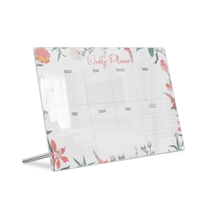 Close-up of floral acrylic weekly planner board with metal stand and notes section
