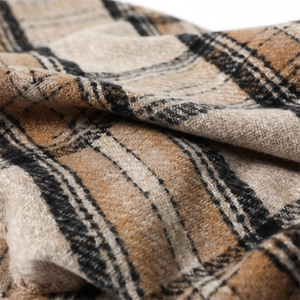 Close-up detail of soft plaid faux cashmere fabric with thick texture in brown and beige