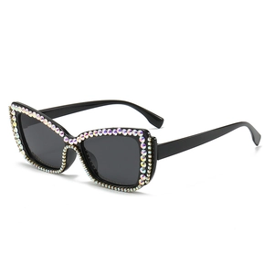 Luxury cat-eye sunglasses for women with black frames and sparkling colorful rhinestones