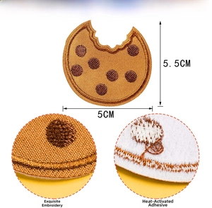 Macro detail of cookie embroidery patch with dimensions and adhesive backing view