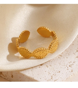 Detail shot of vintage embossed texture on golden open stainless steel ring