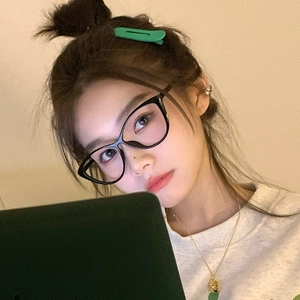 Close-up of model wearing black cat-eye glasses frame with blue light blocking lenses