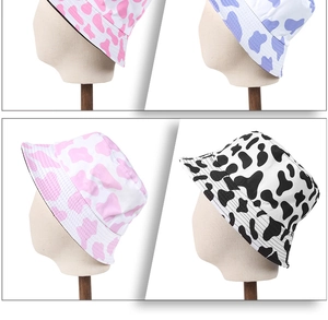 Collage of cow print bucket hats in pink, purple, and black and white patterns